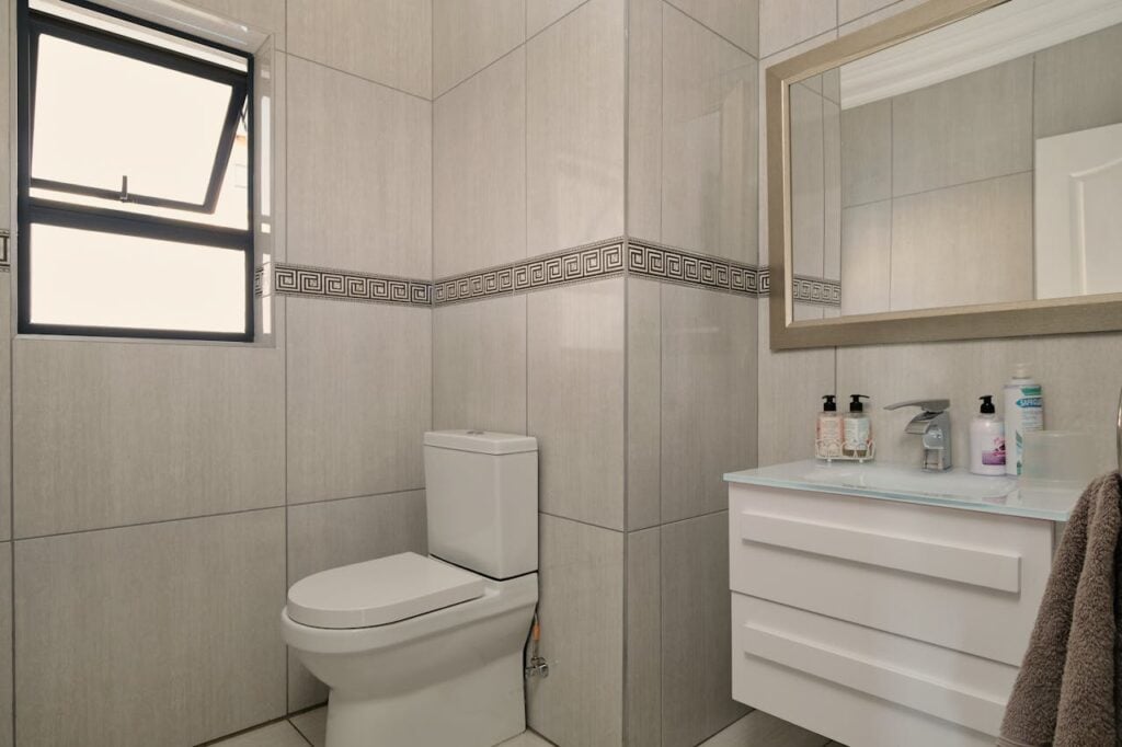 pexels-photo-20748737 A bathroom with a toilet, sink and mirror