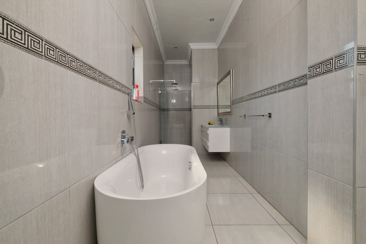 A bathroom with a tub and a shower