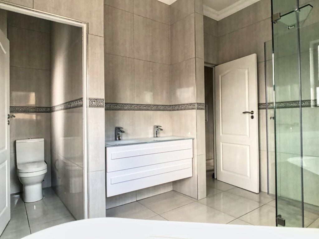 pexels-photo-20803758 A bathroom with a large glass shower and toilet