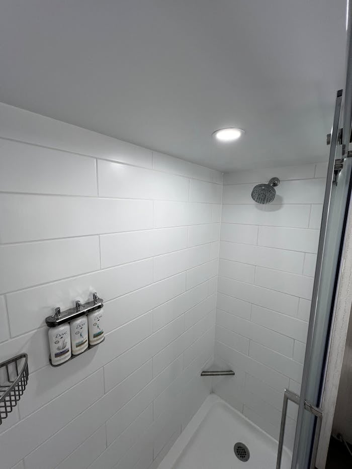 pexels-photo-20817528 A white shower with a light above it